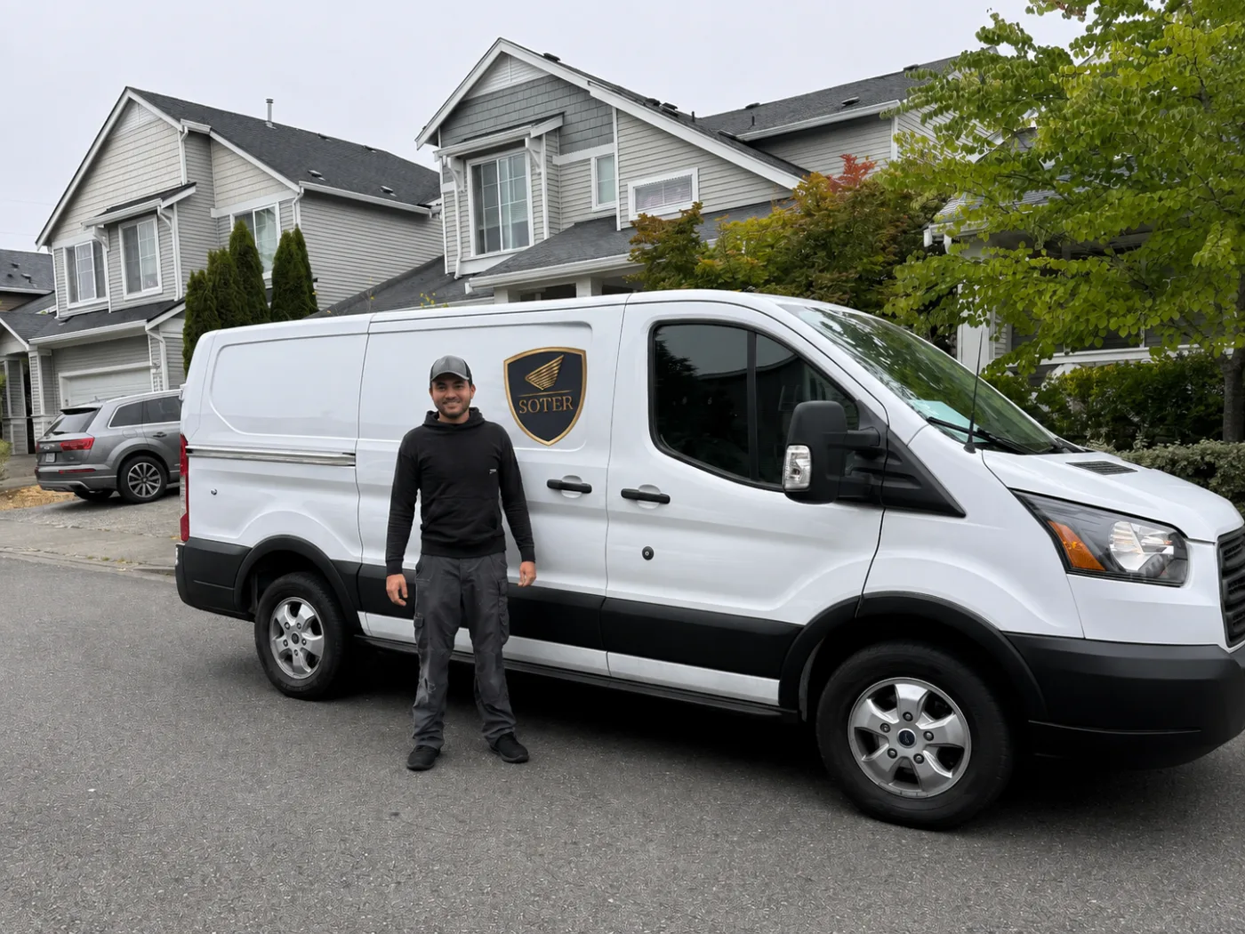 Nathan Wolf with the branded Soter Auto mobile service van in a South Sound neighborhood