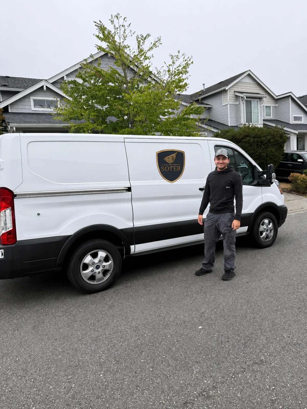 Nathan Wolf standing beside the Soter Auto mobile service van in a South Sound driveway